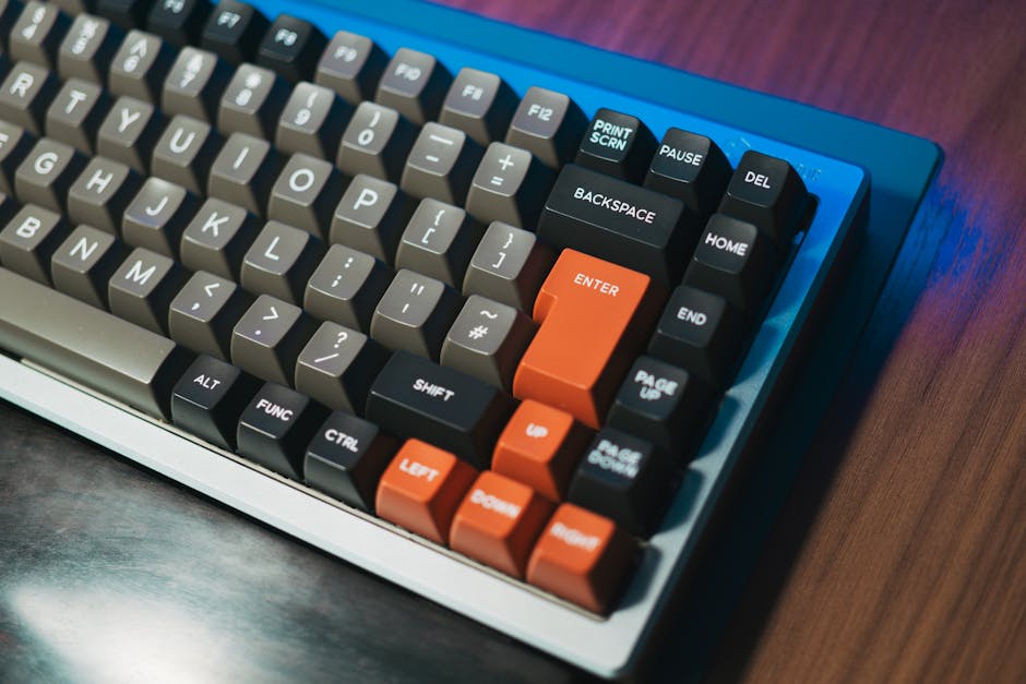 Detailed close-up of a mechanical keyboard with colored keycaps on a wooden desk. Ideal for tech enthusiasts.